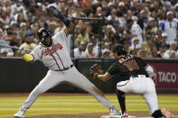 Atlanta Braves' Marcell Ozuna leans out of the way from the tag by Arizona Diamondbacks third baseman Josh Rojas during the sixth inning of a baseball game Saturday, June 3, 2023, in Phoenix. Ozuna advanced on a single by Orlando Arcia. (AP Photo/Darryl Webb)