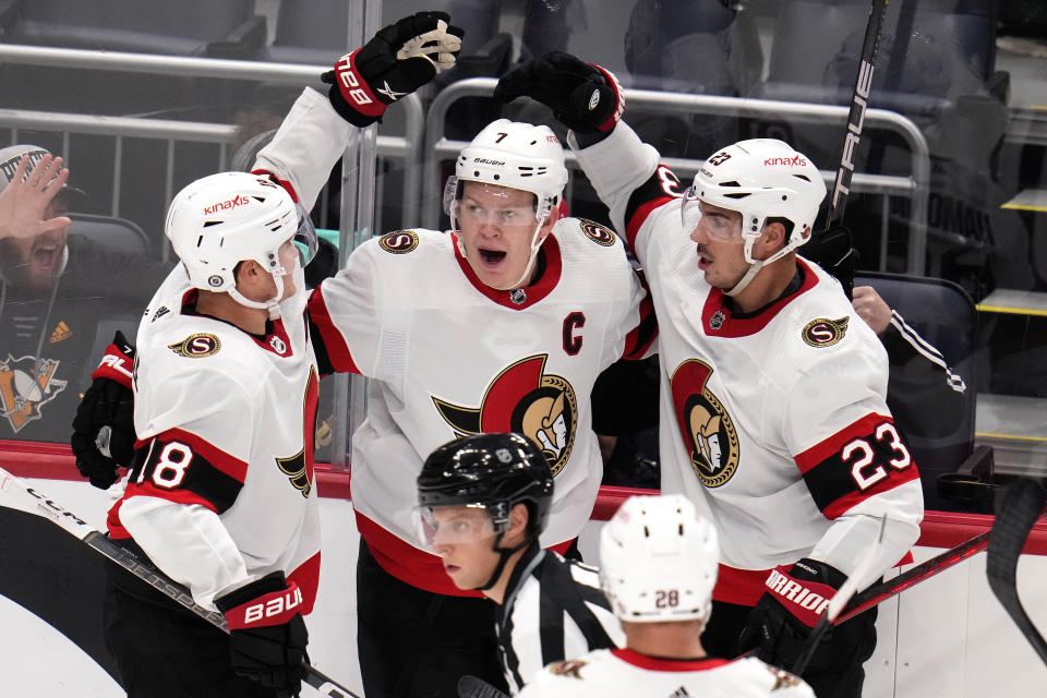 Ottawa Senators' Brady Tkachuk (7) celebrates after his goal with Tim Stutzle (18), Travis Hamonic (23) and Claude Giroux (28) during the third period of an NHL hockey game against the Pittsburgh Penguins in Pittsburgh, Saturday, Oct. 28, 2023. It was Tkachuk's second goal of the game. (AP Photo/Gene J. Puskar)