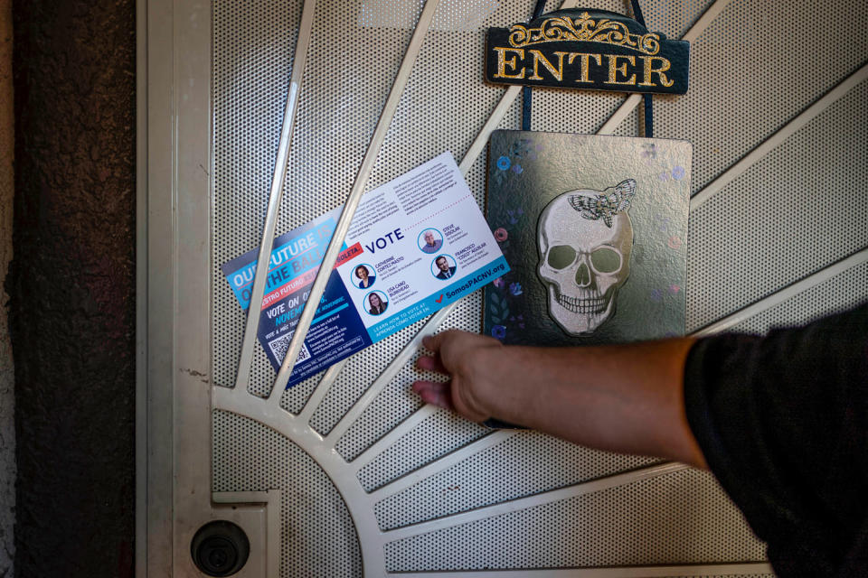 Victor Villenueva leaves a pamphlet at the door of a Nevada voter (Melina Mara / The Washington Post via Getty Images file)