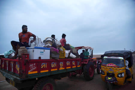 Villagers sit on a vehicle as they leave for a safer place ahead of cylcone Fani on the outskirts of Konark in the eastern state of Odisha, India, May 2, 2019. REUTERS/Stringer NO RESALES. NO ARCHIVES