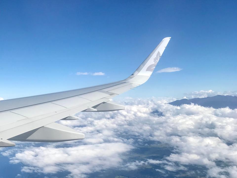 the view from an airplane window of the plane's tail