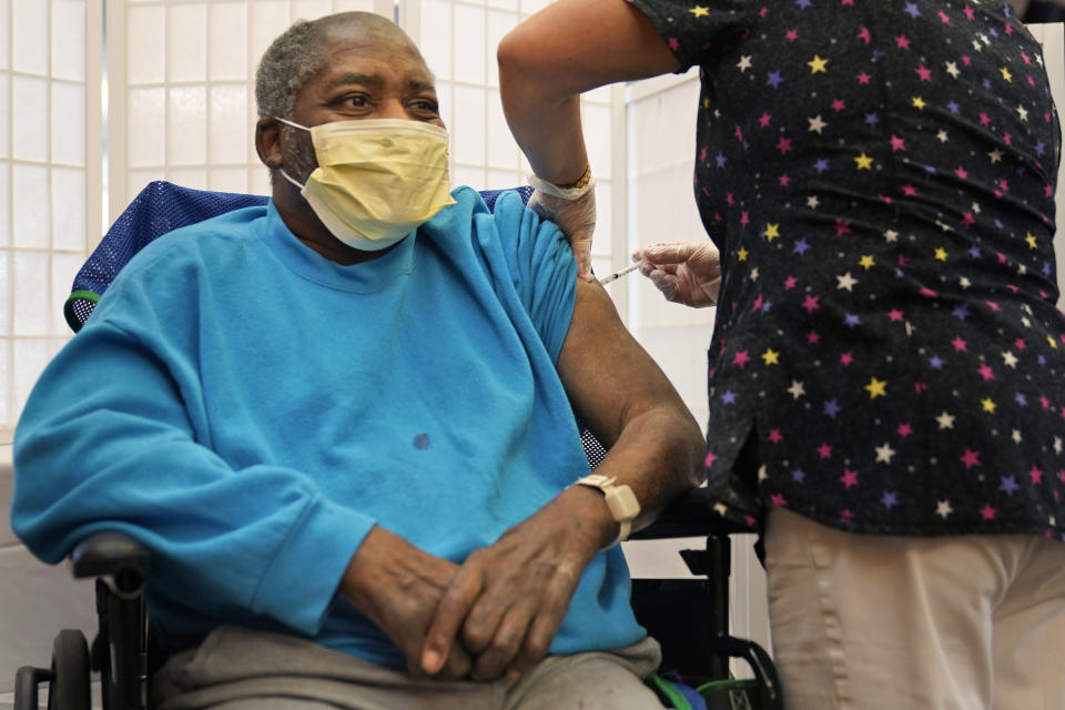 FILE - In this Sept. 27, 2021, file photo, Edward Williams, 62, a resident at the Hebrew Home at Riverdale, receives a COVID-19 booster shot in New York. The number of COVID-19 vaccinations is falling in the U.S. And some experts worry that the decision to give booster doses could end up hurting efforts to get the unvaccinated to take shots at all. (AP Photo/Seth Wenig)