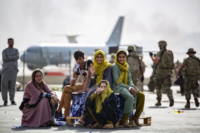Evacuee children wait for the next flight after being manifested at Hamid Karzai International Airport, in Kabul, Afghanistan, on August 19, 2021. File Photo by 1st Lt. Mark Andries/USMC