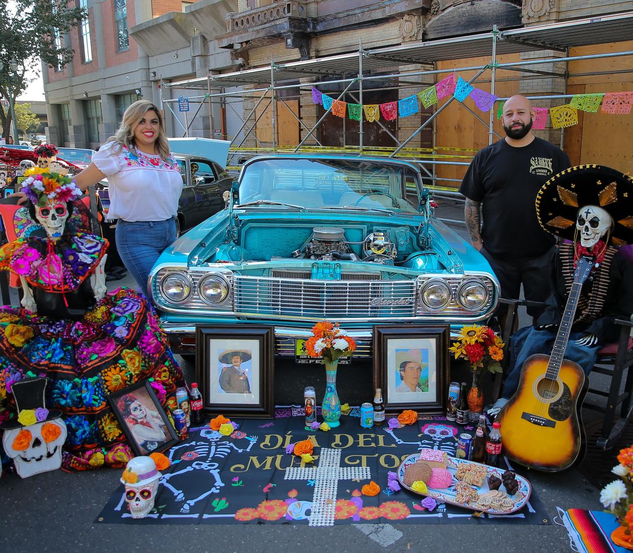 A couple show their love for those lost by dressing their altar with their loved ones favorite things at the Dia de los Muertos at the Mexican Heritage Center in downtown Stockton. Dan Rogers for the Record.