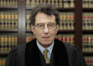 FILE - This Jan. 11, 2018 file photo shows Judge Dan Polster in his office, in Cleveland. Negotiations aimed at reaching a major settlement in the nation's opioid litigation reached an impasse Friday, Oct. 18, 2019. U.S. District Court Judge Polster has said he wants the parties to strike a settlement in such a way that it would make a real difference in resolving the crisis. He invited state attorneys general to participate in the negotiations even though their lawsuits against the industry were filed in state courts. (AP Photo/Tony Dejak, File)