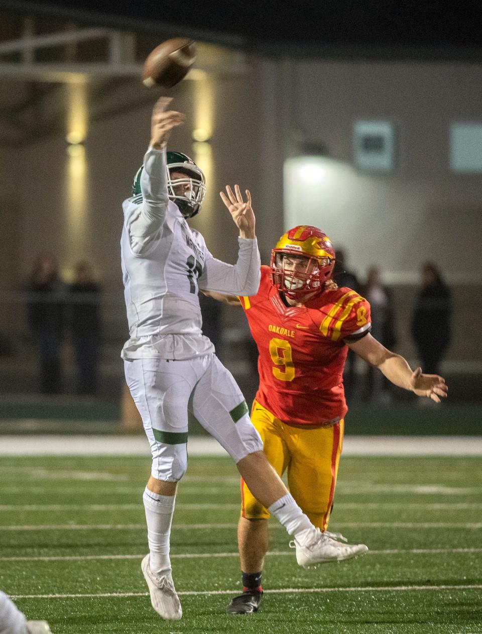 Manteca's Hudson Wyatt, left, throws a pass under pressure from Oakdale's Brock Osmondson during the Sac-Joaquin Section Division III championship game at St. Mary's High School in Stockton. Wyatt's teammate  Zion Allen caught the pass and ran in for the game-winning touchdown. Manteca won 35-28.