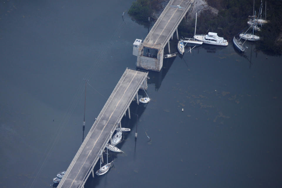 <p>A bridge with boats washed up under it are pictured in an aerial photo in the Keys in Marathon, Fla., Sept. 13, 2017. (Photo: Carlo Allegri/Reuters) </p>