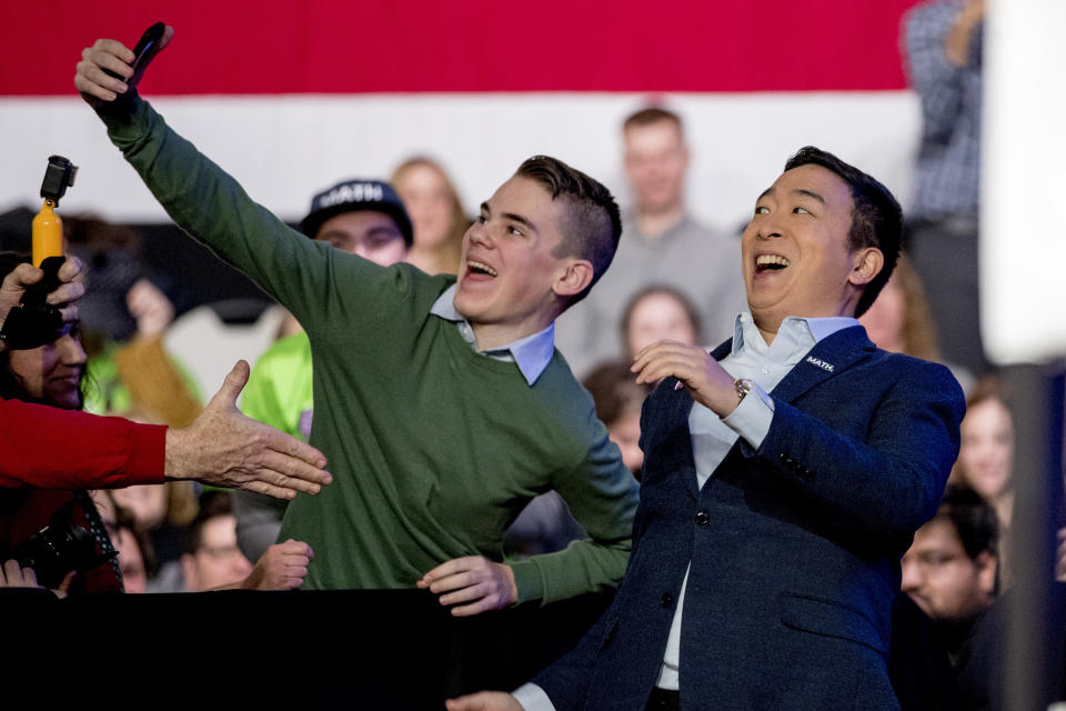 Democratic presidential candidate Andrew Yang takes a photograph with a member of the audience as he arrives at "Our Rights, Our Courts" forum New Hampshire Technical Institute's Concord Community College, Saturday, Feb. 8, 2020, in Concord, N.H. (AP Photo/Andrew Harnik)