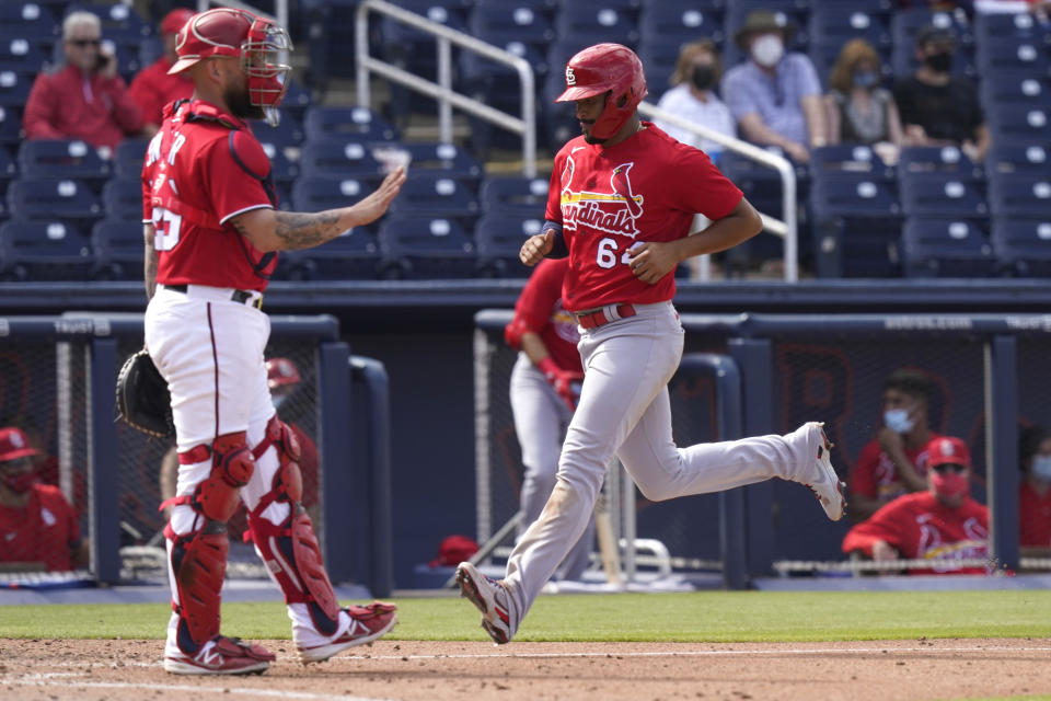 St. Louis Cardinals' Jose Rondon (64) scores on a sacrifice fly hit by Nolan Arenado during the seventh inning of a spring training baseball game against the Washington Nationals, Wednesday, March 10, 2021, in West Palm Beach, Fla. (AP Photo/Lynne Sladky)