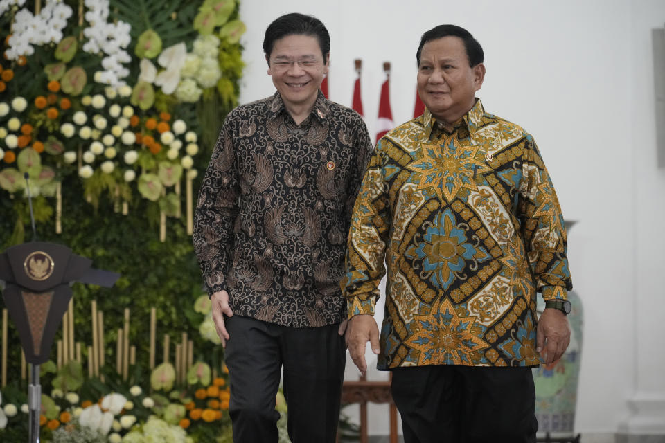 Indonesian Defense Minister and president-elect Prabowo Subianto, right, and Singapore's Deputy Prime Minister and Finance Minister Lawrence Wong walk during their meeting at Bogor Presidential Palace in Bogor, Indonesia, Monday, April 29, 2024. (AP Photo/Achmad Ibrahim)