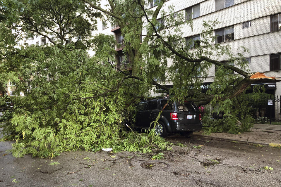 A downed tree limb blocks a roadway in Chicago's Lakeview neighborhood on Monday, Aug. 10, 2020. A rare storm packing 100 mph winds and with power similar to an inland hurricane swept across the Midwest on Monday, blowing over trees, flipping vehicles, causing widespread property damage, and leaving hundreds of thousands without power as it moved through Chicago and into Indiana and Michigan. (AP Photo/Tom Berman)