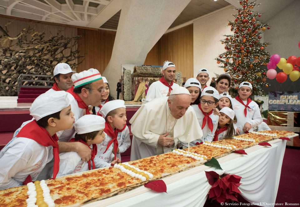 Pope Francis blows on a candle&nbsp;to celebrate his birthday during a special meeting at Paul VI hall at the Vatican on Dec.&nbsp;17, 2017. (Photo: Osservatore Romano / Reuters)