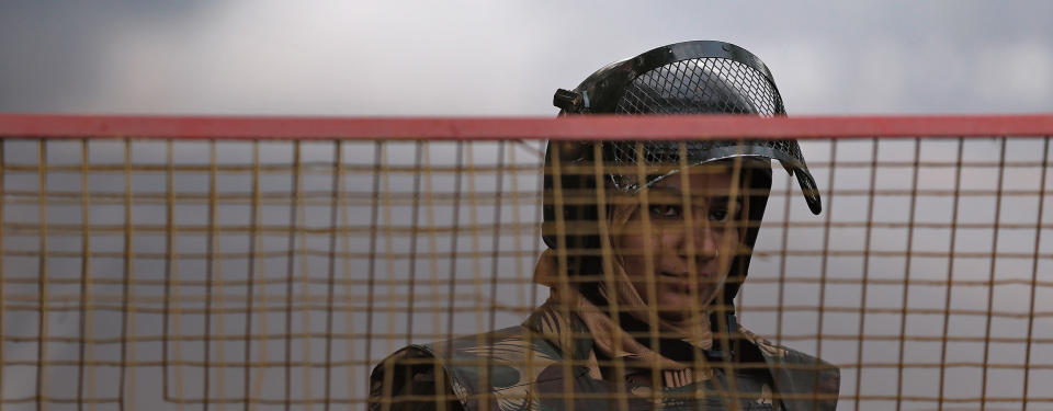 A policewoman stands guard at a barricade to stop protesters, near India Gate in New Delhi December 29, 2012. The Indian gang rape victim whose assault in New Delhi triggered nationwide protests died of her injuries on Saturday in a Singapore hospital, potentially threatening fresh protests in India where her case is a rallying point for women's rights. REUTERS/Adnan Abidi (INDIA - Tags: CRIME LAW CIVIL UNREST TPX IMAGES OF THE DAY)