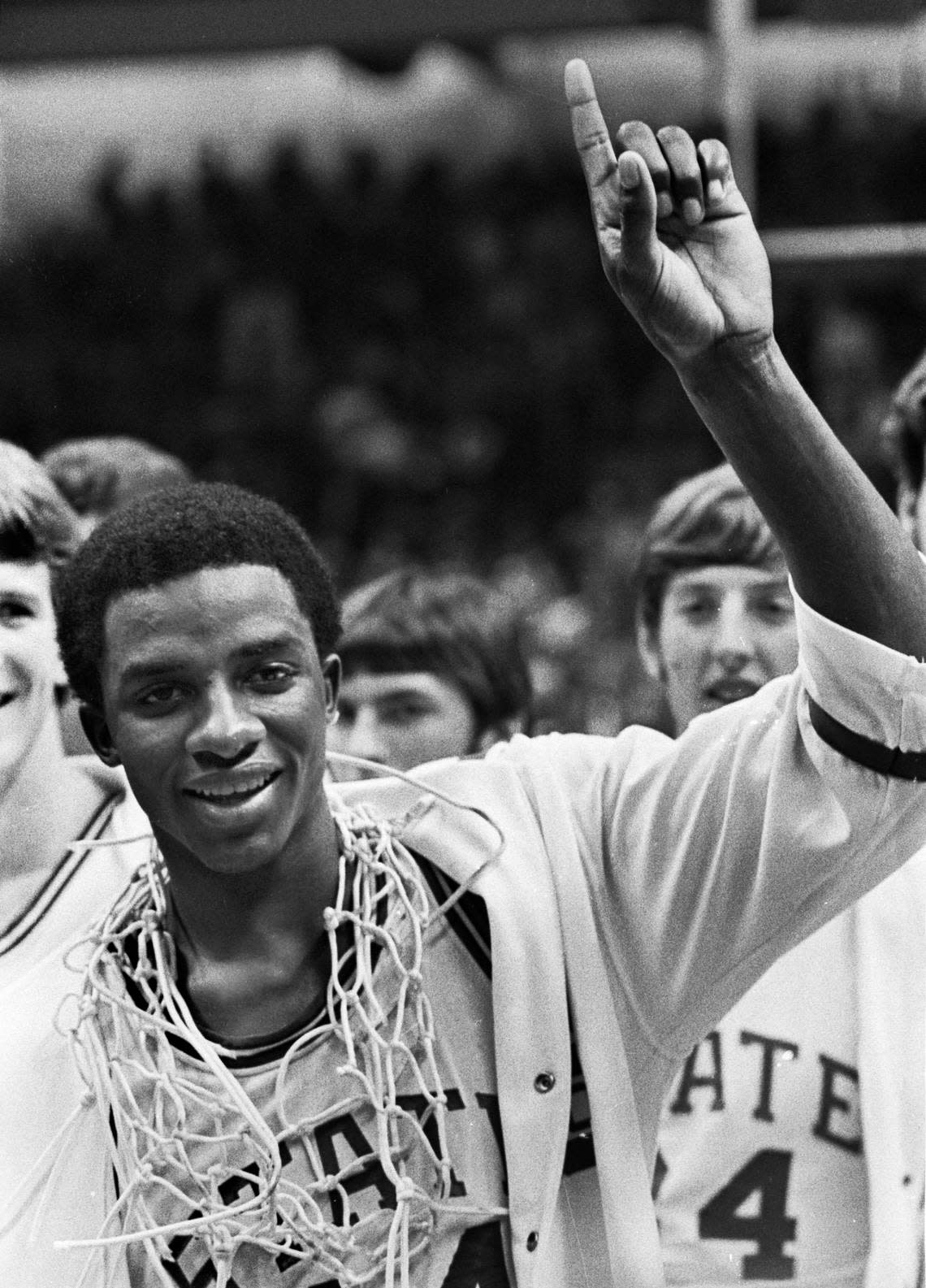 David Thompson, wearing one of the game nets around his neck, celebrate’s the Wolfpack’s 1974 National Championship win over Marquette.