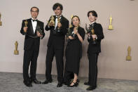 FILE - Masaki Takahashi, from left, Takashi Yamazaki, Kiyoko Shibuya, and Tatsuji Nojima pose in the press room with the award for best visual effects for "Godzilla Minus One" at the Oscars on March 10, 2024, at the Dolby Theatre in Los Angeles. One Japanese creation grabbing attention on the Oscars red carpet wasn't a movie: the kitsch shoes that seemed to be clenched in Godzilla's claw. They were the work of Ryosuke Matsui, who recently described his joy at seeing “Godzilla Minus One” director Takashi Yamazaki and his Shirogumi special-effects team walk the red carpet and win the visual effects Oscar, all while wearing his shoes. (Photo by Jordan Strauss/Invision/AP, File)