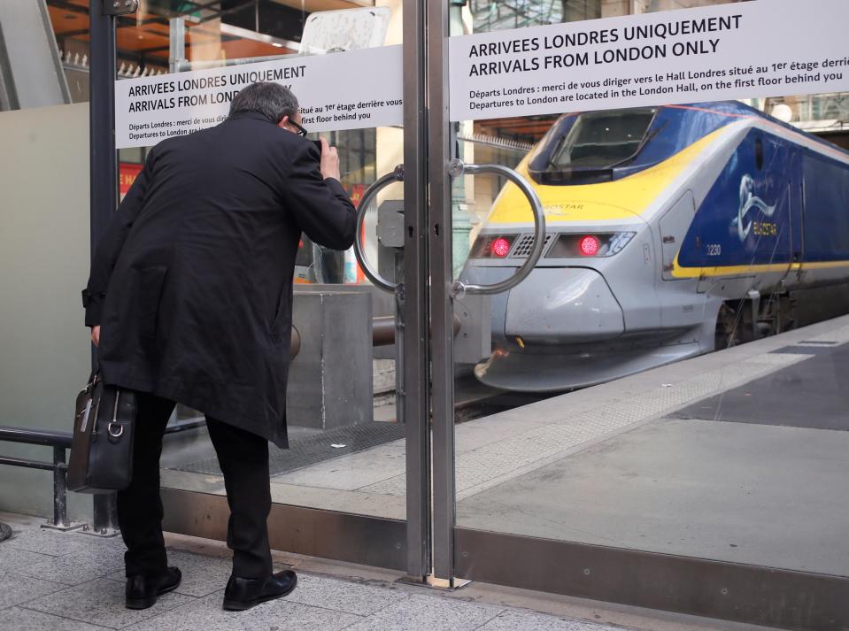 A passenger takes a picture of a stationary Eurostar train as industrial action continued on Thursday (Francois Mori/AP)