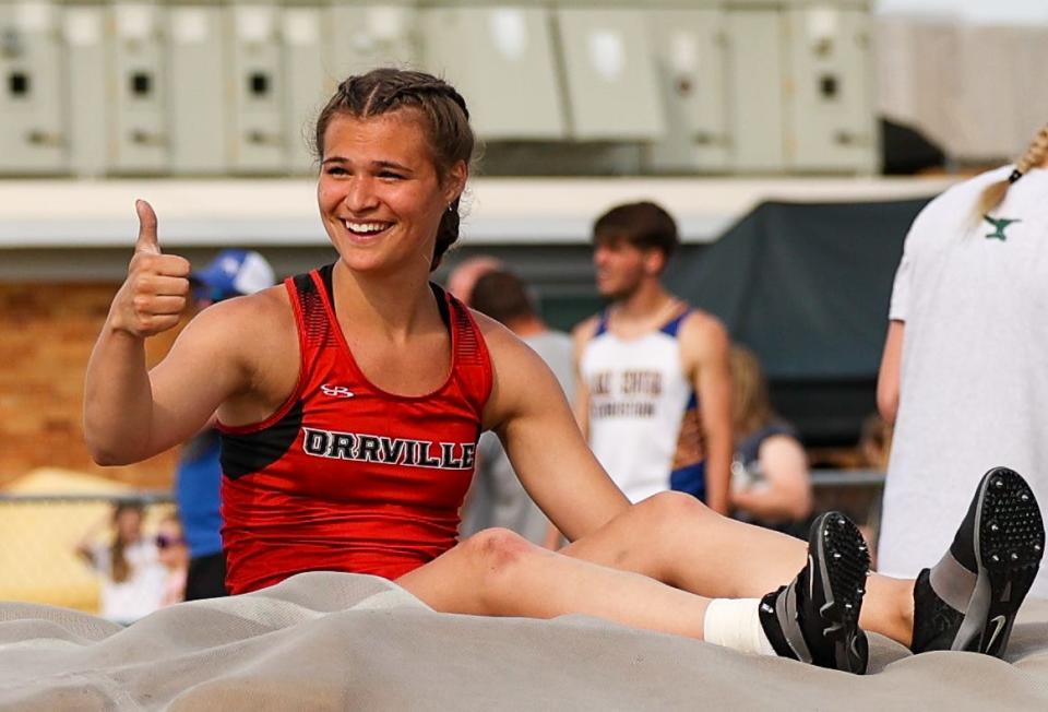 Orrville's Ainsley Hamsher is all smiles as she gives the thumb's up to her coaches after winning the pole vault.