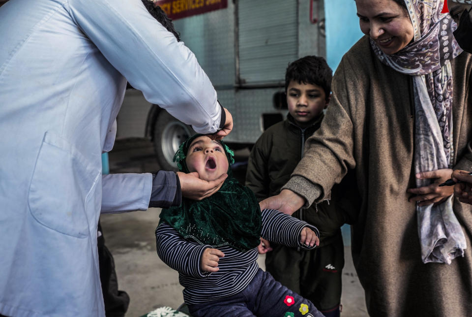 A government health worker administers polio drops to a child in Srinagar, Indian controlled Kashmir, Sunday, Mar. 3, 2024. (AP Photo/Mukhtar Khan)