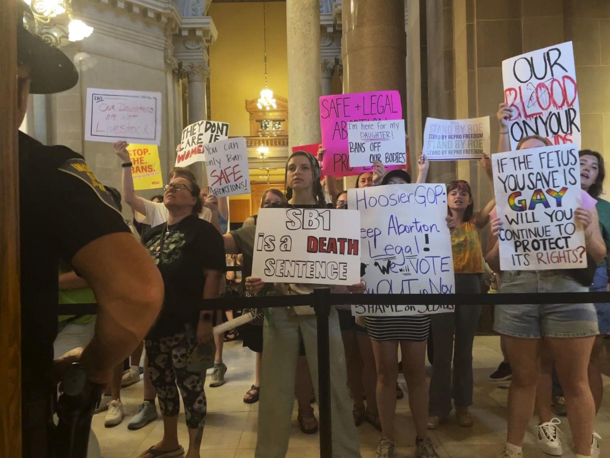 Abortion-rights protesters fill Indiana Statehouse corridors and cheer outside legislative chambers Friday.