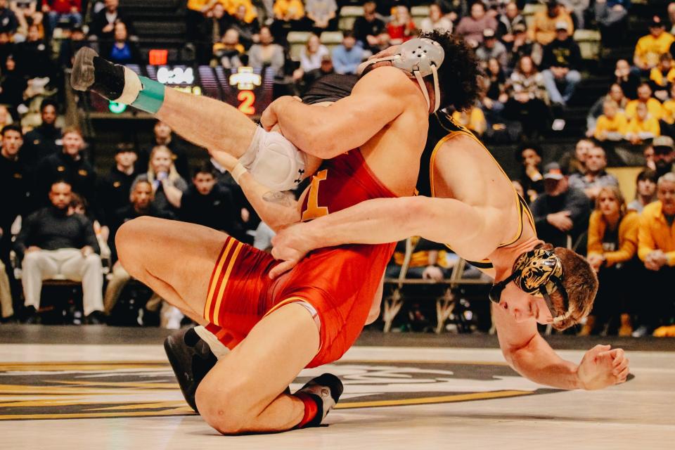 Iowa State's Yonger Bastida, left, throws Missouri's Rocky Elam, right, back on to the mat during the 197-pound match in the Tigers' loss to the Cyclones on Wednesday at the Hearnes Center. Bastida won by a takedown in sudden death.