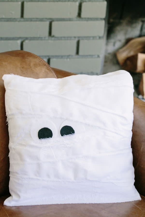 <p>This fun little throw pillow may look like an ambitious DIY project, but <a href="https://sugarandcharm.com/2014/10/no-sew-diy-mummy-pillow.html" rel="nofollow noopener" target="_blank" data-ylk="slk:Sugar and Charm;elm:context_link;itc:0;sec:content-canvas" class="link ">Sugar and Charm</a> assures it's not. In fact, it doesn't even require any sewing! </p><p><a class="link " href="https://www.amazon.com/Aleenes-15626-No-Sew-Fabric-Glue/dp/B00114RF8O/ref=sr_1_3?tag=syn-yahoo-20&ascsubtag=%5Bartid%7C10057.g.2554%5Bsrc%7Cyahoo-us" rel="nofollow noopener" target="_blank" data-ylk="slk:BUY NOW;elm:context_link;itc:0;sec:content-canvas">BUY NOW</a> <strong><em>No-Sew Fabric Glue, $5</em></strong></p>