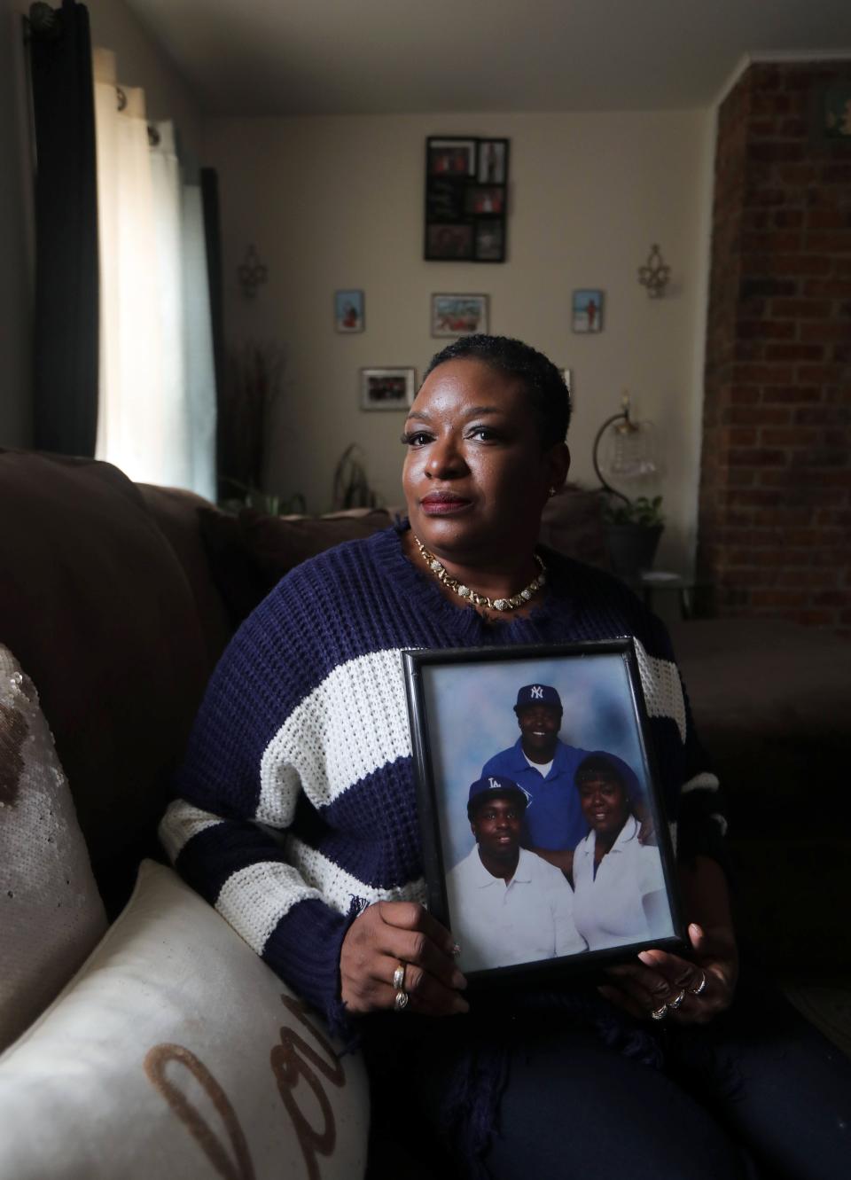 Desiree Chambers, 52, of Troy, N.Y. holds a portrait of her children April 6, 2022.