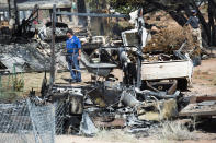 <p>Fire investigators walk among the property destroyed by the fire near Pack Creek, in Moab, Utah, Wednesday, June 13, 2018. (Photo: Rick Egan/The Salt Lake Tribune via AP) </p>