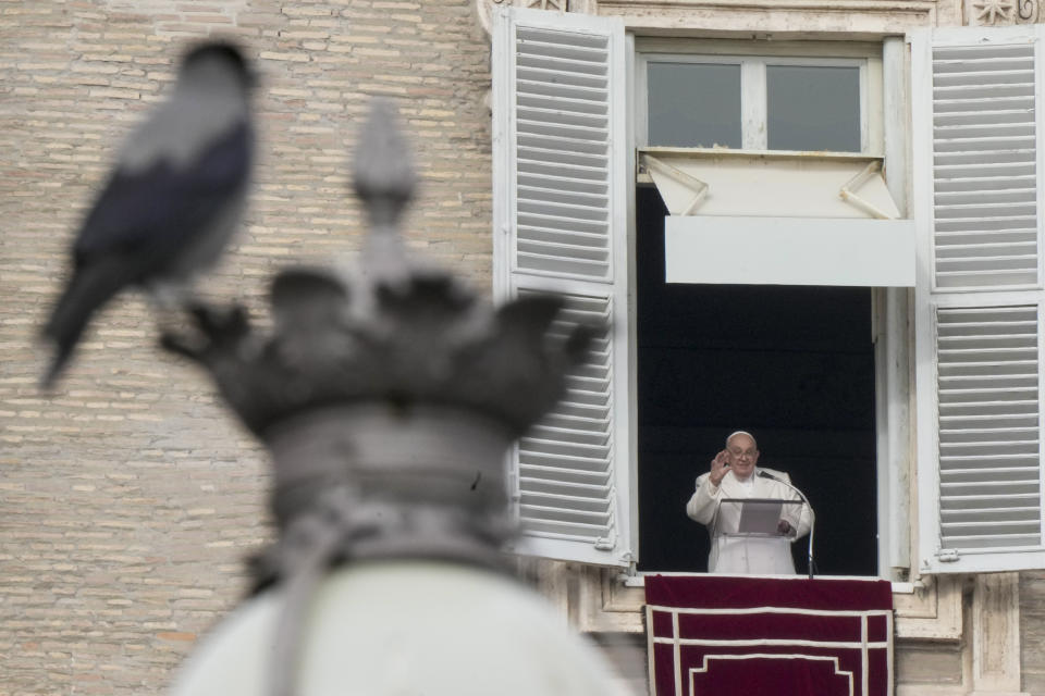 Pope Francis delivers his blessing as he recites the Angelus noon prayer from the window of his studio overlooking St. Peter's Square, at the Vatican, Friday, Dec. 8, 2023. (AP Photo/Andrew Medichini)