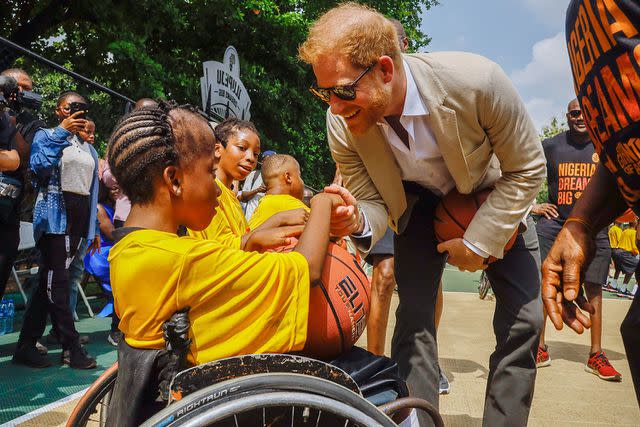 <p>Andrew Esiebo/Getty</p> Prince Harry visits Giants of Africa at Ilupeju Senior Grammar School on May 12, 2024 in Lagos, Nigeria.