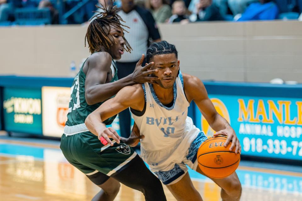 Bartlesville High School guard David Castillo, right, drives to the basket against Muskogee during a January game in Bartlesville. Castillo, who transferred to Sunrise Academy for his senior year, signed a letter of intent with Kansas State on Wednesday.