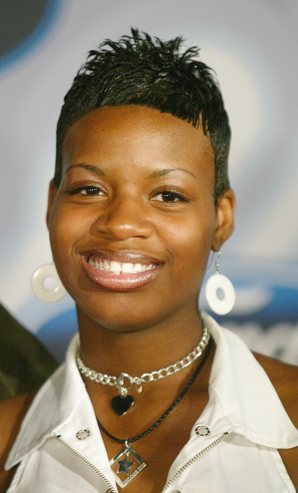 close up of Fantasia in short hair, choker necklaces and