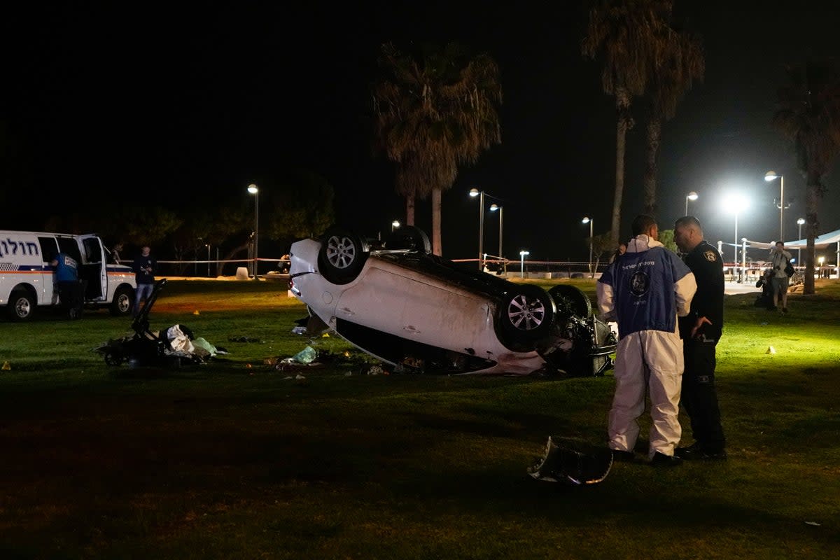 Israeli police stand at the scene of an attack in Tel Aviv (Ariel Schalit/AP) (AP)