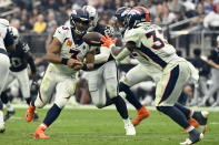 Denver Broncos quarterback Russell Wilson (3) hands off to running back Javonte Williams (33) during the second half of an NFL football game against the Las Vegas Raiders, Sunday, Oct. 2, 2022, in Las Vegas. (AP Photo/David Becker)
