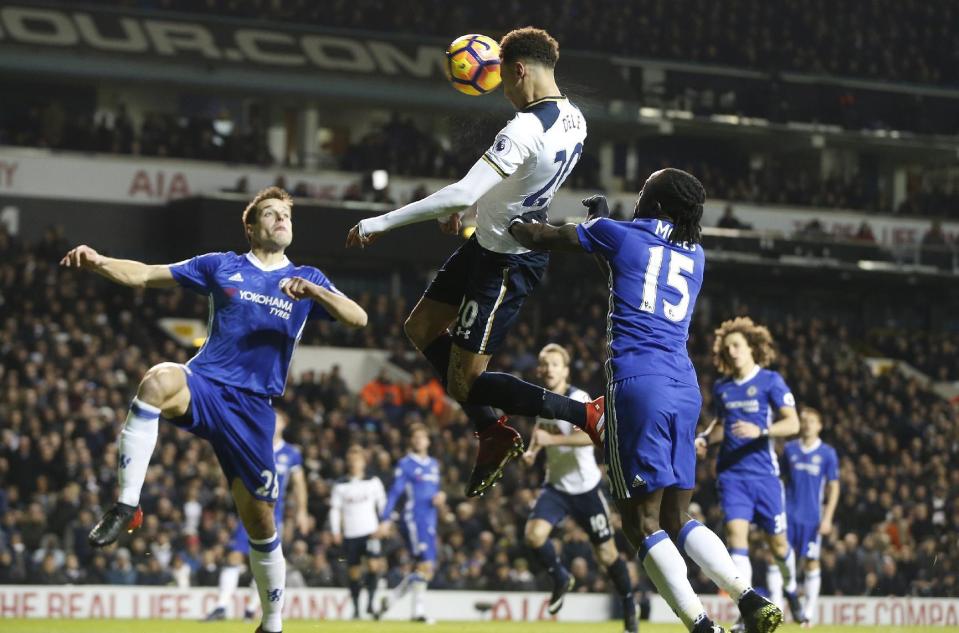Tottenham's Dele Alli, centre, scores a goal during the English Premier League soccer match between Tottenham Hotspur and Chelsea at White Hart Lane stadium in London, Wednesday, Jan. 4, 2017. (AP Photo/Alastair Grant)