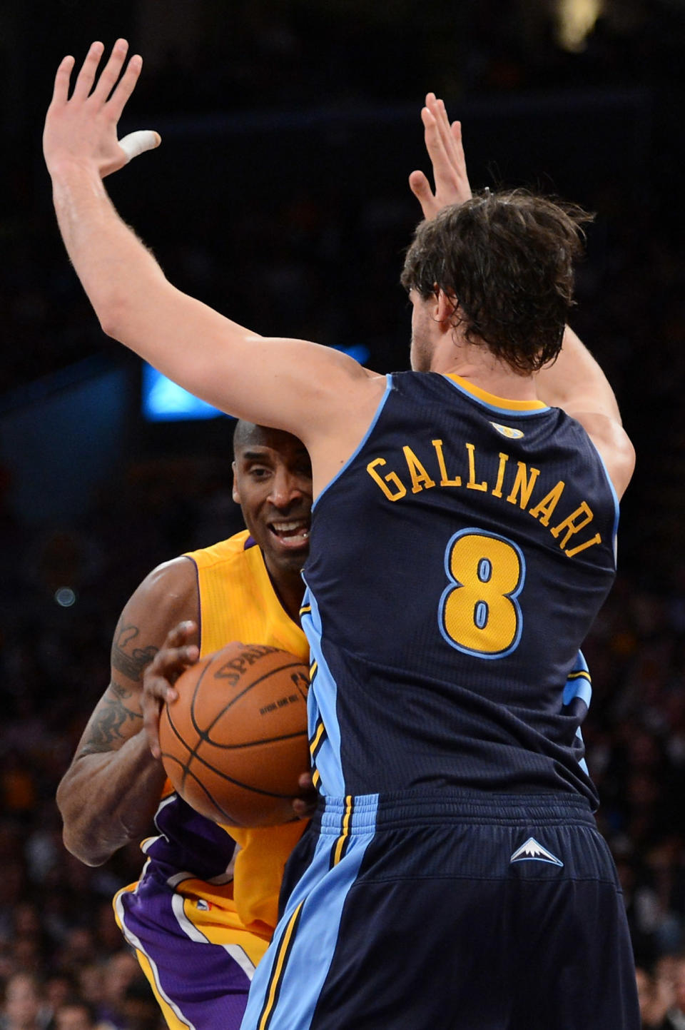 LOS ANGELES, CA - MAY 12: Kobe Bryant #24 of the Los Angeles Lakers drives into Danilo Gallinari #8 of the Denver Nuggets in the first half in Game Seven of the Western Conference Quarterfinals in the 2012 NBA Playoffs on May 12, 2012 at Staples Center in Los Angeles, California. NOTE TO USER: User expressly acknowledges and agrees that, by downloading and or using this photograph, User is consenting to the terms and conditions of the Getty Images License Agreement. (Photo by Harry How/Getty Images)