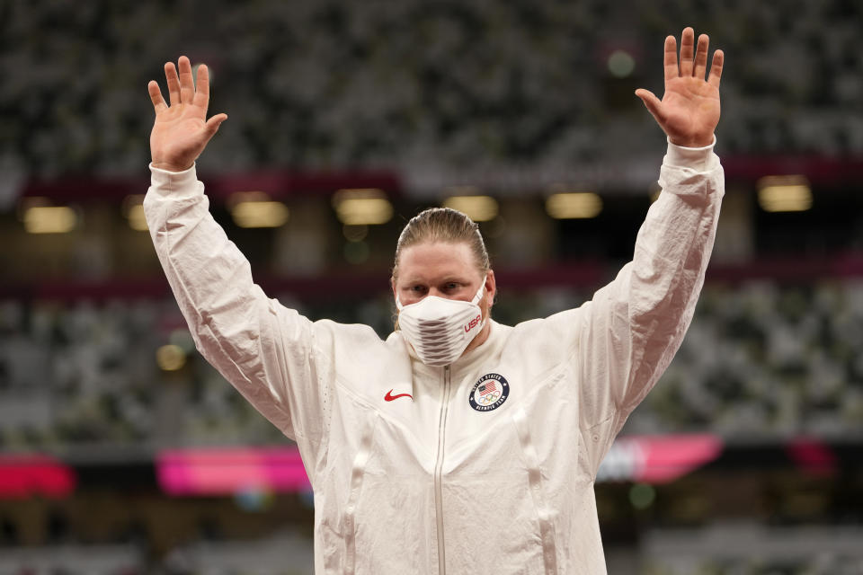 Gold medalist Ryan Crouser, of the United States, waves during the medal ceremony for the men's shot put at the 2020 Summer Olympics, Thursday, Aug. 5, 2021, in Tokyo. (AP Photo/Martin Meissner)