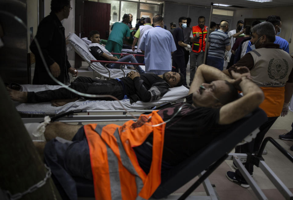 Palestinians receive treatment at the Shifa Hospital from their wounds caused by an Israeli airstrike that destroyed the upper floors of a commercial building and caused damage to the nearby Health Ministry and prime health care clinic, in Gaza City, Monday, May 17, 2021. (AP Photo/Khalil Hamra)