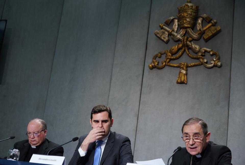 From left, Malta's Archbishop Charles Scicluna, Vatican spokesman Alessandro Gisotti and Mons. Juan Ignacio Arrieta talk to journalists during a press conference to present the new sex abuse law, at the Vatican's press room, Rome, Thursday, May 9, 2019. Pope Francis issued a groundbreaking law Thursday requiring all Catholic priests and nuns around the world to report clergy sexual abuse and cover-up by their superiors to church authorities, in an important new effort to hold the Catholic hierarchy accountable for failing to protect their flocks. (AP Photo/Andrew Medichini)