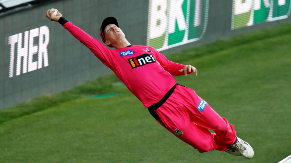 Pictured here, Jordan Silk flies high to stop a six in the Big Bash.