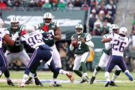 Dec 21, 2014; East Rutherford, NJ, USA; New York Jets quarterback Geno Smith (7) drops back to pass against the New England Patriots during the third quarter at MetLife Stadium. The Patriots defeated the Jets 17-16. Mandatory Credit: Brad Penner-USA TODAY Sports