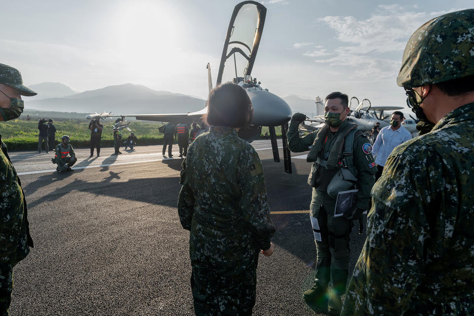 In this photo released by the Taiwan Presidential Office, Taiwanese President Tsai Ing-wen, center, speaks with military personnel near aircraft parked on a highway in Jiadong, Taiwan, Wednesday, Sept. 15, 2021. Four military aircraft landed on the highway and took off again on Wednesday as part of Taiwan's five-day Han Guang military exercise designed to prepare the island's forces for an attack by China, which claims Taiwan as part of its own territory. (Taiwan Presidential Office via AP)