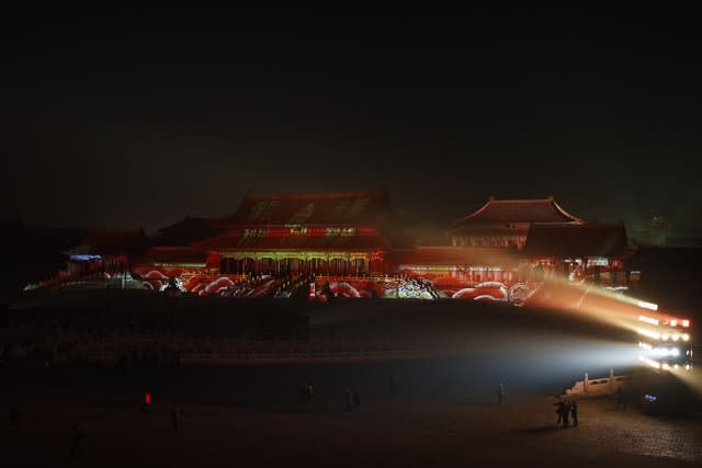 Visitors tour the Forbidden City projected with colourful lights during the Lantern Festival in Beijing