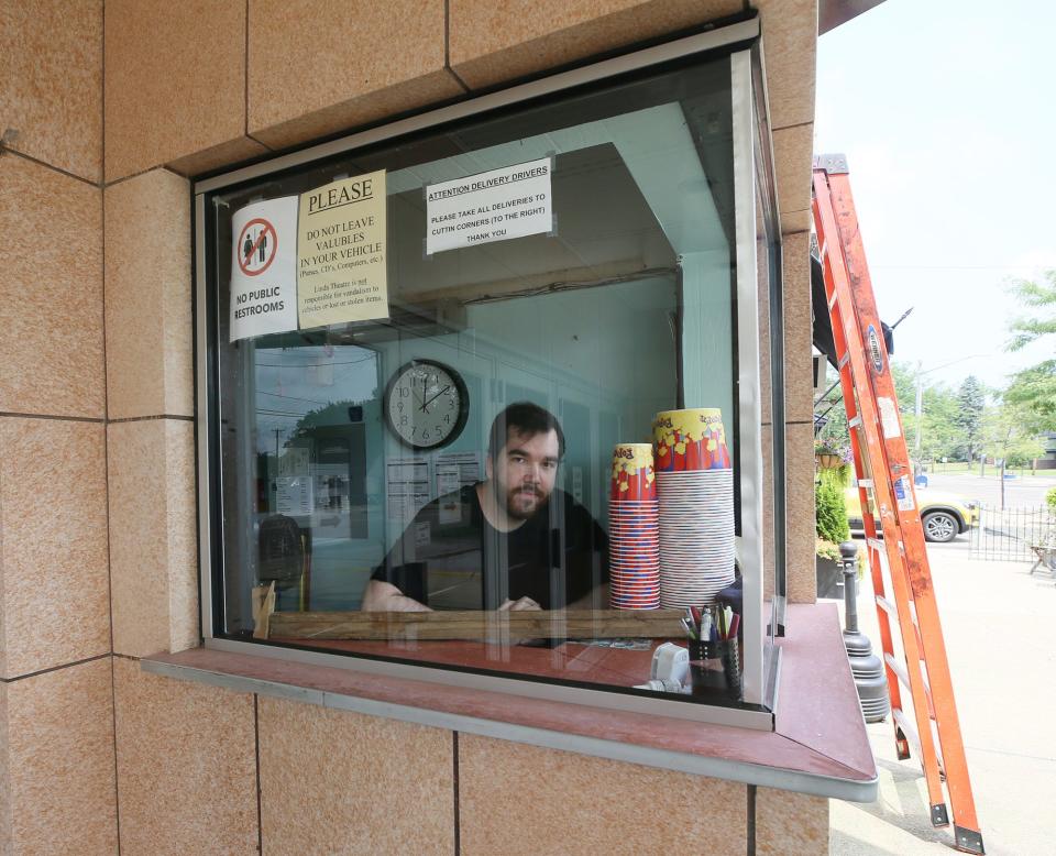 Kyle Sommers talks about upgrades to the Linda Theater to the while in the ticket booth in Akron.