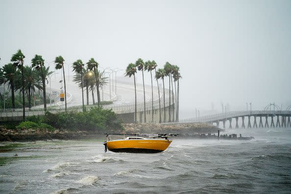 A sailboat is beached at Sarasota Bay as Hurricane Ian approaches on September 28, 2022, in Sarasota, Florida.