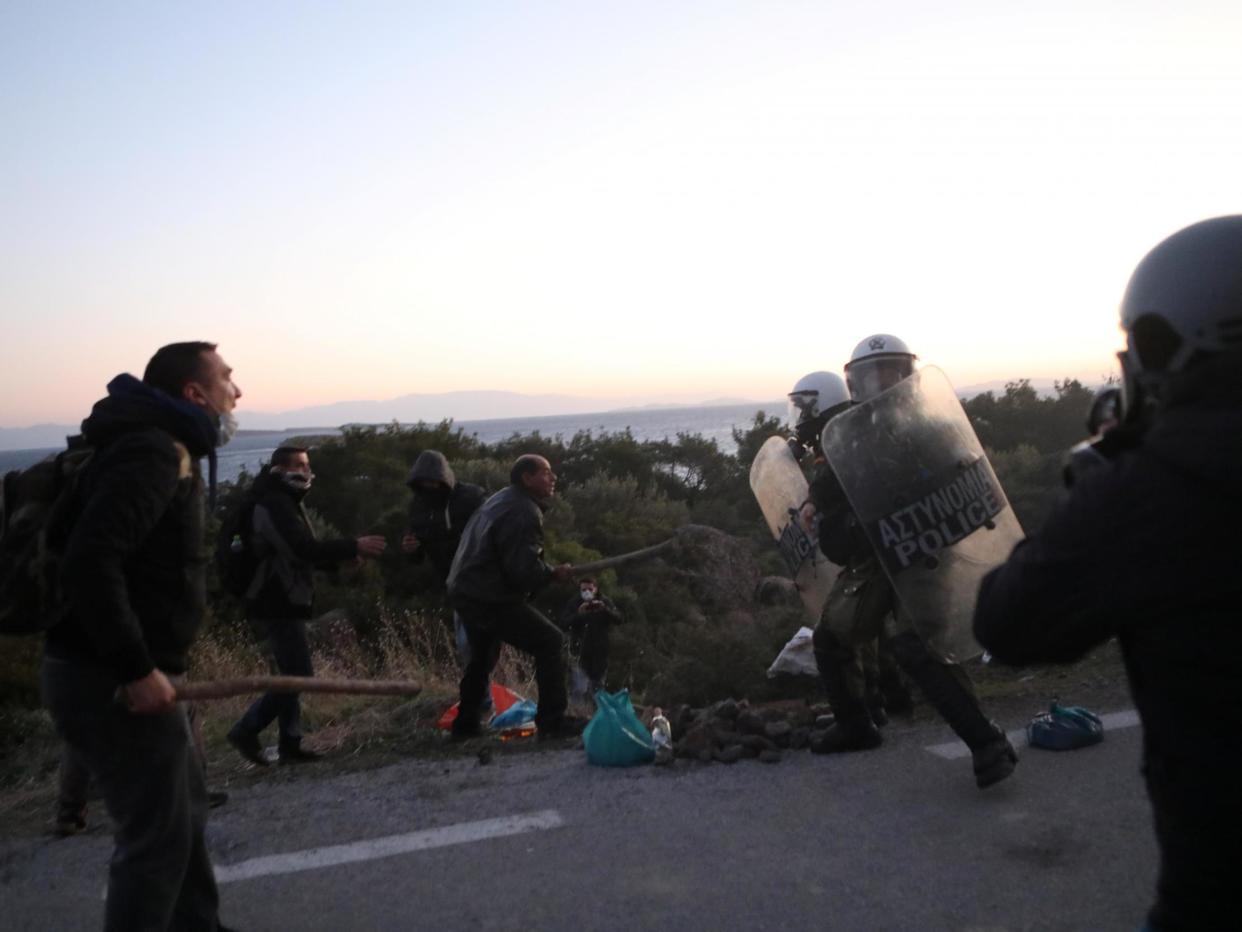 Locals scuffle with riot police on Lesbos during protests against a planned new migrant centre: Reuters