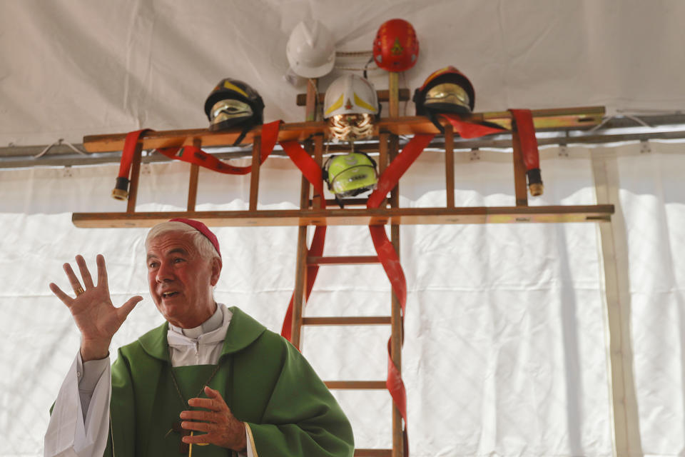 <p>A cross made with ladders and firefighter helmets is placed inside a tent during a Mass celebrated by Bishop Giovanni D’Ercole at a tent camp set up as a temporary shelter for the earthquake survivors in Arquata Del Tronto, near Amatrice, central Italy, Aug. 28, 2016. (AP Photo/Gregorio Borgia) </p>