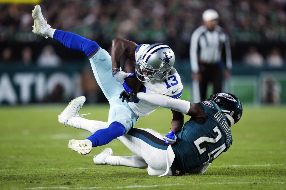 Dallas Cowboys wide receiver Michael Gallup (13) is brought down by Philadelphia Eagles cornerback James Bradberry (24) during the second half of an NFL football game Sunday, Nov. 5, 2023, in Philadelphia. (AP Photo/Matt Rourke)