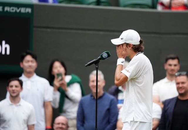 Alex De Minaur looks distressed