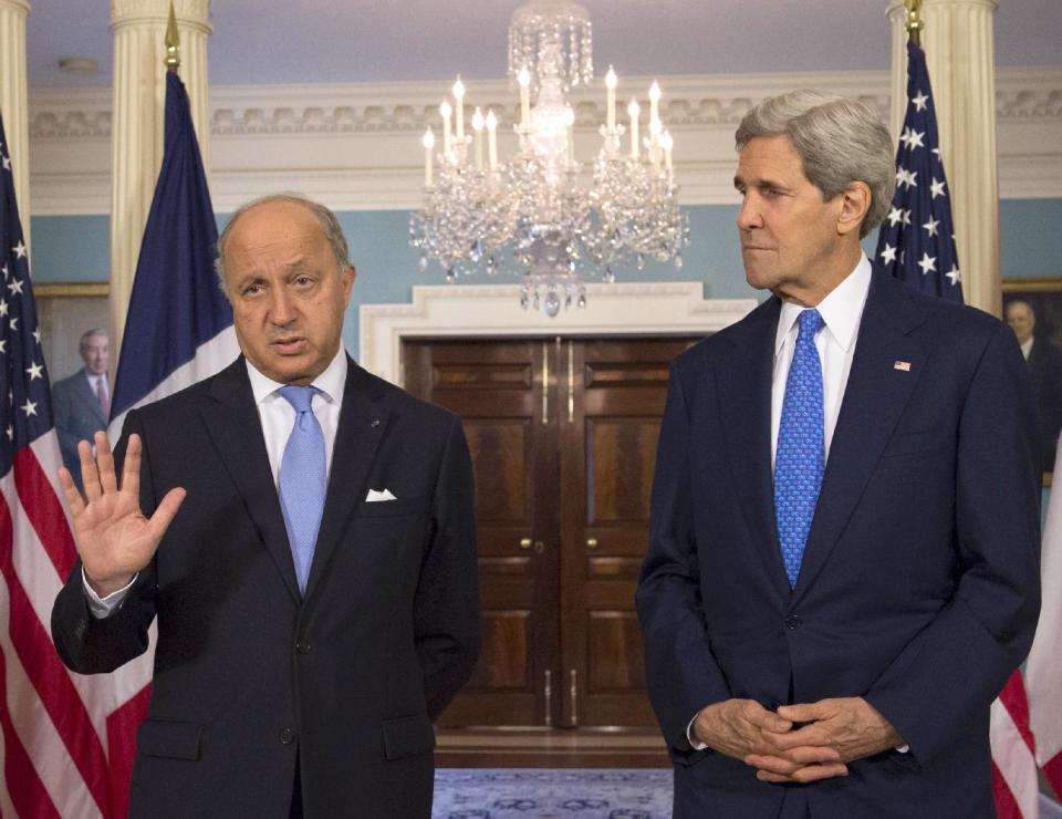 Secretary of State John Kerry listens as French Foreign Minister Laurent Fabius speaks prior to their meeting at the State Department in Washington, Tuesday, May 13, 2014. (AP Photo/Molly Riley)