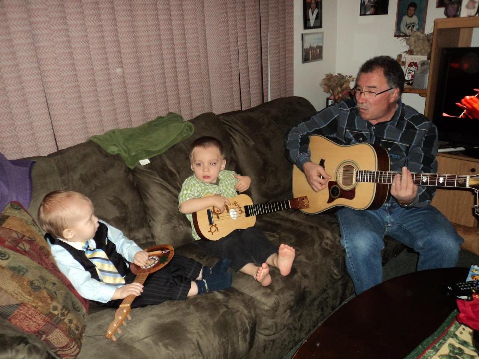 William Tagoona says he puts on a band performance with his family every Christmas. Here, he's singing to his grandsons Harden and Armand Tagoona.